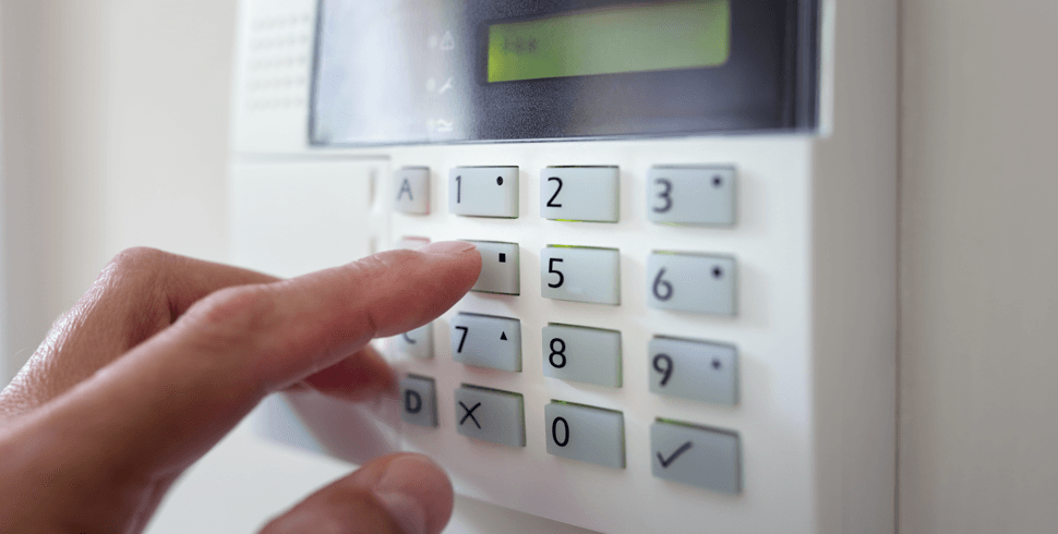 Person turning on alarm system 